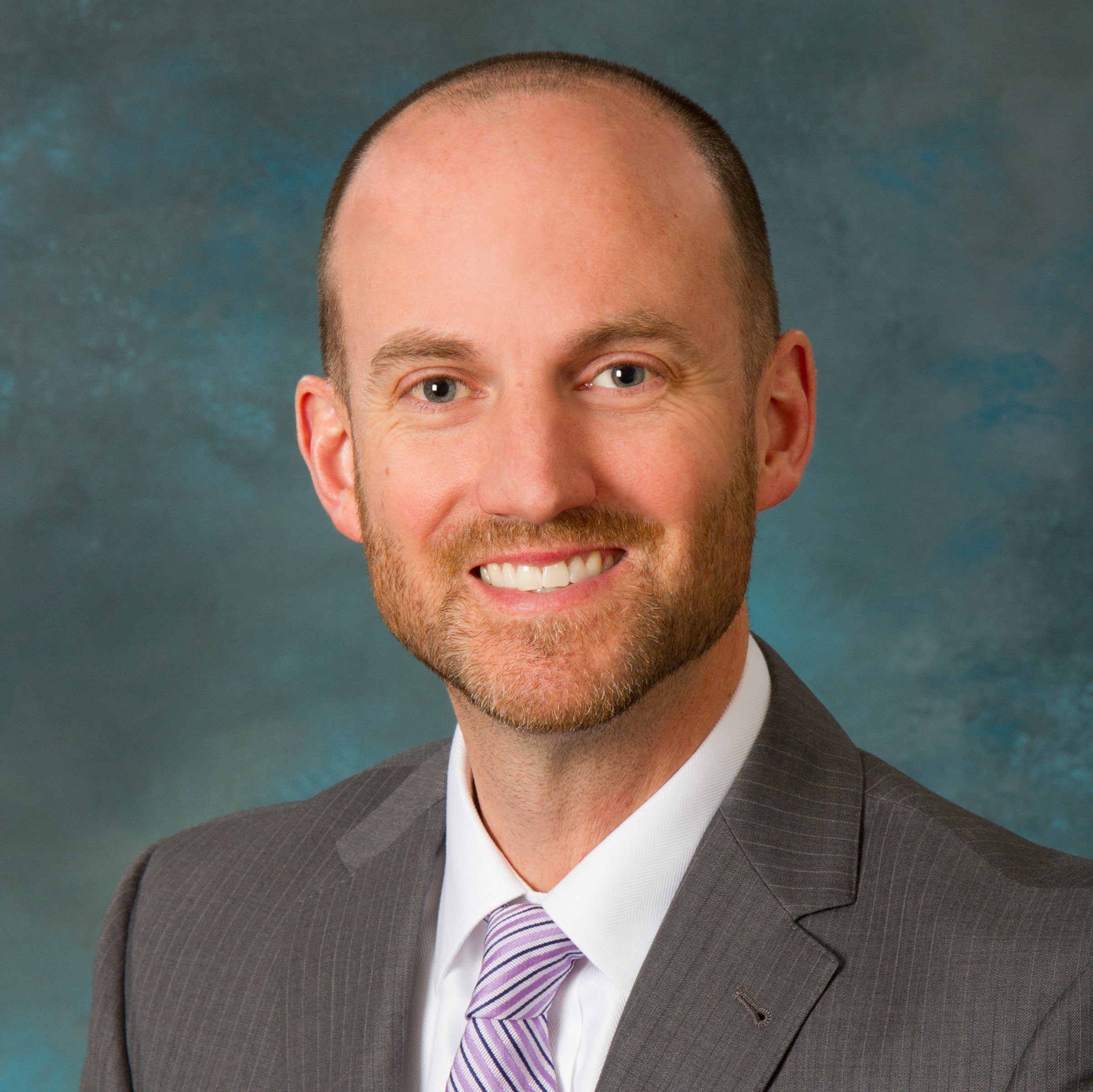 a headshot of John Morey is pictured.